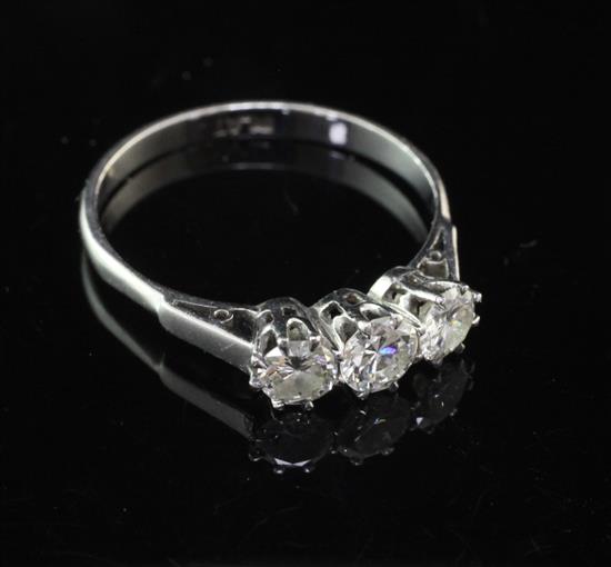 A platinum and three stone diamond ring, size O.